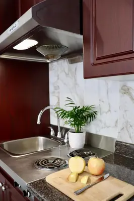 a kitchen counter with a cutting board with apples on it at August Jack Inn in Squamish
