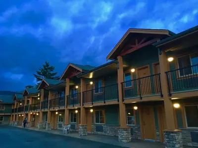 a row of apartment buildings at night at Vedder River Inn in Chilliwack