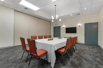 a conference room with a white table and chairs at Best Western PLUS Burnaby Hotel in Burnaby