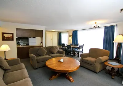 a living room with a couch and chairs and a table at Heron's Landing Hotel in Campbell River