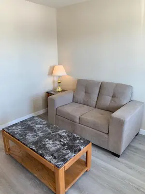 a living room with a couch and a coffee table at Red Deer Inn & Suites in Red Deer