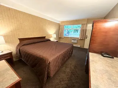 a hotel room with a bed and a window at Linda Vista Motel in Surrey