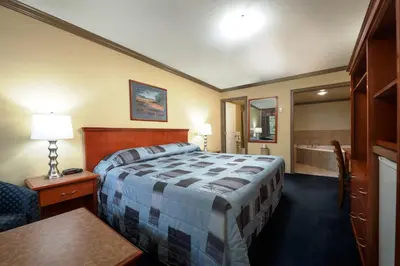 a hotel room with a bed and a bathroom at Linda Vista Motel in Surrey