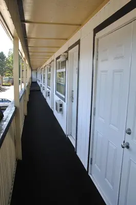 a corridor of a school hallway with a white door at Linda Vista Motel in Surrey