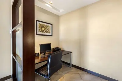 a room with a desk with a computer on it at Best Western Plus Edmonton Airport Hotel in Leduc