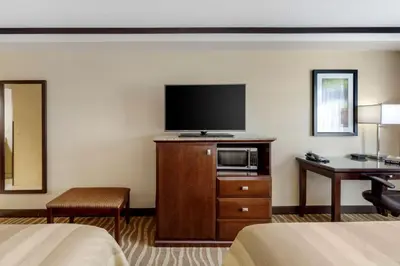 a hotel room with a flat screen tv and a bed at Best Western Plus Edmonton Airport Hotel in Leduc