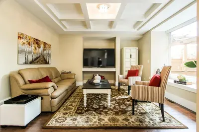 a living room with a couch and a table at CHATHAM HOUSE Kelowna Bed & Breakfast in Kelowna
