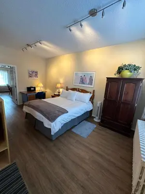 a bedroom with a large bed in a room at Burns Lake Bed and Breakfast in Burns Lake