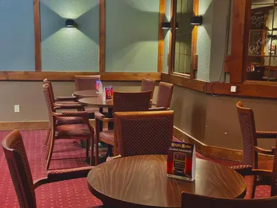 a row of tables and chairs in a restaurant at Lacombe Motor Inn in Lacombe