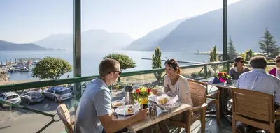 a group of people sitting at a table in a restaurant at Harrison Hot Springs Resort & Spa in Harrison Hot Springs