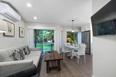 a living room with a couch and a table at Ocean Trails Resort in Parksville