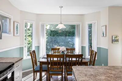 a kitchen with a dining room table and chairs at Ocean Trails Resort in Parksville