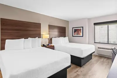 a hotel room with two beds and a window at Best Western Maple Ridge in Maple Ridge District Municipality