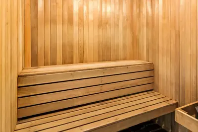 a wooden sauna with a wooden bench in it at Best Western Maple Ridge in Maple Ridge District Municipality