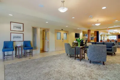 a lobby with blue chairs and a dining room at Best Western PLUS Chemainus Inn in Chemainus