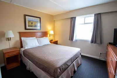 a hotel room with a bed and a window at Canadas Best Value Inn-Prince George in Prince George