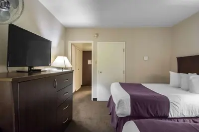 a hotel room with a bed and a flat screen tv at Quality Inn & Suites Yellowknife in Yellowknife