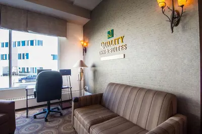 a waiting room with a leather couch and a desk at Quality Inn & Suites Yellowknife in Yellowknife