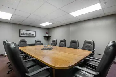 a conference room with a wooden table and chairs at Quality Inn & Suites Yellowknife in Yellowknife