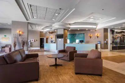 a lobby with couches and chairs and a table at Quality Inn & Suites Yellowknife in Yellowknife