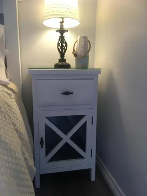 a bedside table with a lamp on top of it at Long Lake Waterfront Bed and Breakfast in Nanaimo