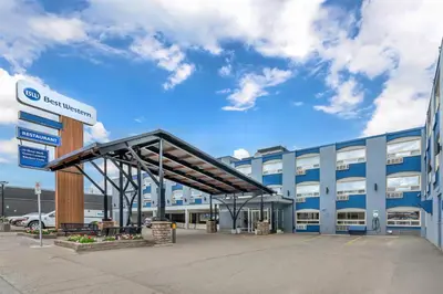 a large blue building with a parking lot at Best Western Prince George Downtown in Prince George