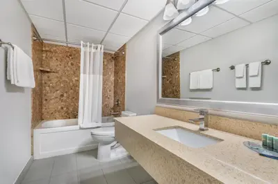 a bathroom with a sink and a toilet and a mirror at Best Western Prince George Downtown in Prince George