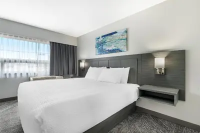 a hotel room with a large bed and a window at Best Western Prince George Downtown in Prince George