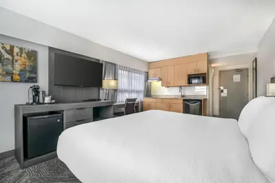 a hotel room with a bed and a kitchen at Best Western Prince George Downtown in Prince George
