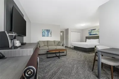 a hotel room with a bed and a couch at Best Western Prince George Downtown in Prince George