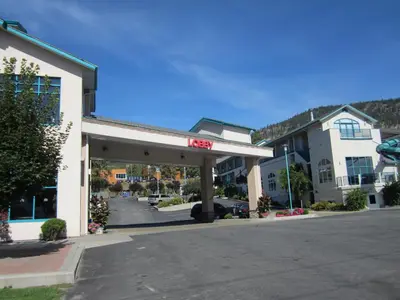 a gas station on a street in a town at Ramada Merritt in Merritt