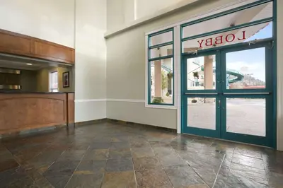 an empty lobby with a door and a window at Ramada Merritt in Merritt