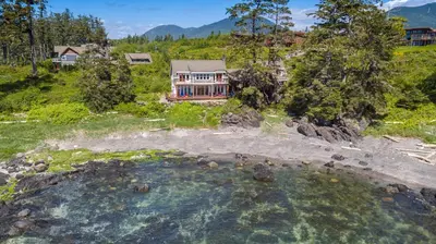 an aerial view of a house with a pool of water at Black Rock Beach House in Ucluelet