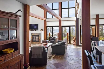 a living room with chairs and a fireplace at Black Rock Ridge in Ucluelet