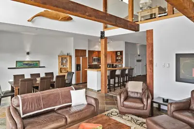 a living room with a couch and chairs and a bar at Black Rock Ridge in Ucluelet