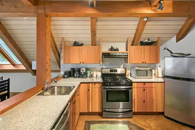 a kitchen with a stove and a sink at Black Rock Landing in Ucluelet