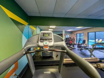 a fitness room with a treadmill in a gym at The Cedars Inn Hotel & Convention Centre in Gibsons