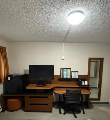 an office with a desk with a computer on it at Canadas Best Value Inn Kelowna in Kelowna