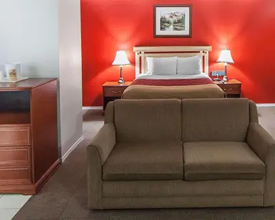 a hotel room with a bed and a couch at Econo Lodge Inn & Suites Drumheller in Drumheller