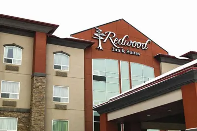 a redwood inn and suites sign on the front of a building at Redwood Inn & Suites in Clairmont