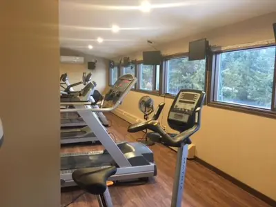 a gym with several exercise bikes in a room at Spruce Hill Resort & Spa in 108 Mile Ranch