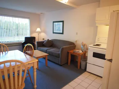 a living room with a couch and a table at Whale's Tail Guest Suites in Ucluelet