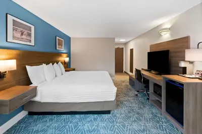 a hotel room with a bed and a desk at Hotel Feng, BW Signature Collection in Parksville