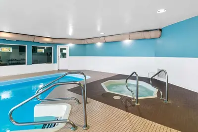 a swimming pool with a hot tub in a building at Hotel Feng, BW Signature Collection in Parksville