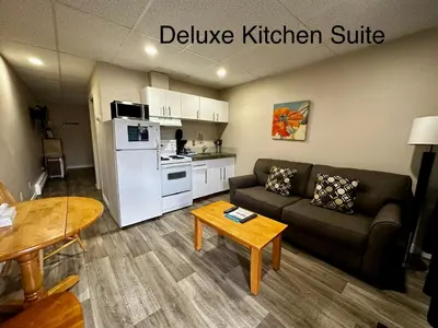 a living room with a couch and a table at West Coast Motel on the Harbour in Ucluelet