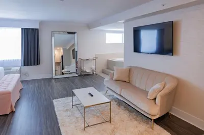 a living room with a couch and a tv at Prestige Treasure Cove Resort in Prince George