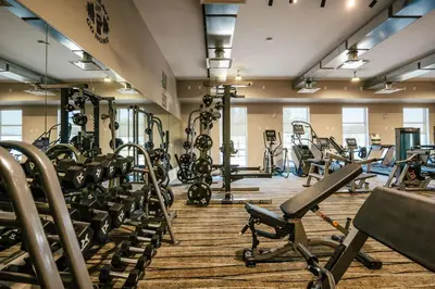 a gym with lots of treadmills and machines at Prestige Treasure Cove Resort in Prince George