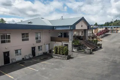 a building with a parking lot in front of it at Port Augusta Inn in Comox