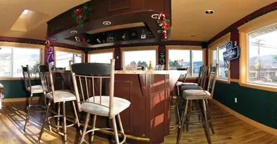 a bar in a restaurant with stools at Travelodge by Wyndham Merritt in Merritt