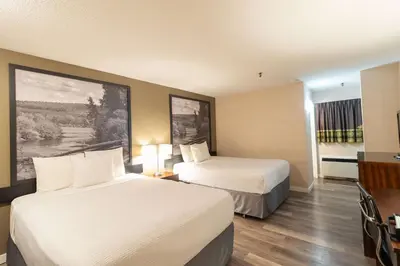 a hotel room with two beds and a television at Super 8 by Wyndham Prince George in Prince George